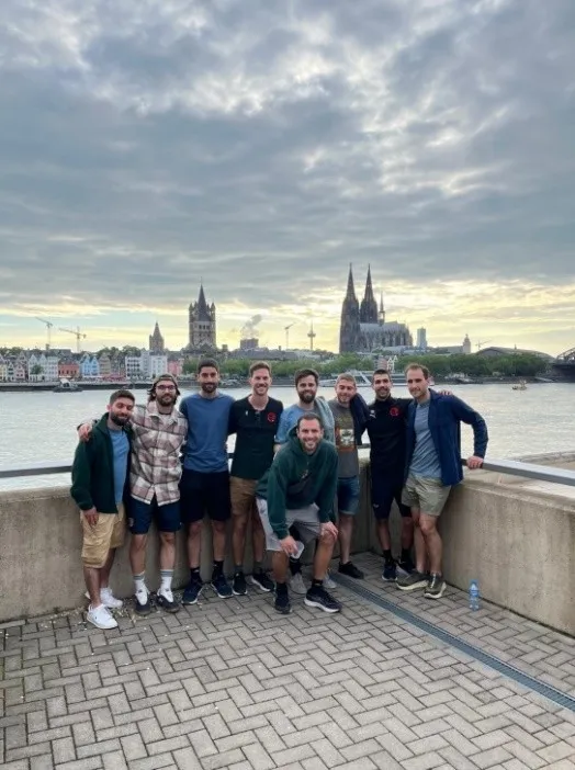 Players by the Rhine with Cologne Cathedral behind them